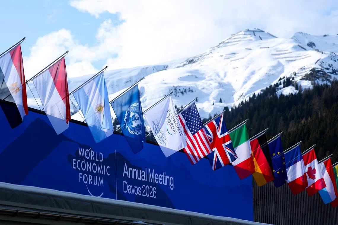 FILE PHOTO: Flags flutter during the 56th annual World Economic Forum (WEF) meeting, in Davos, Switzerland, January 19, 2026. REUTERS/Denis Balibouse/File Photo