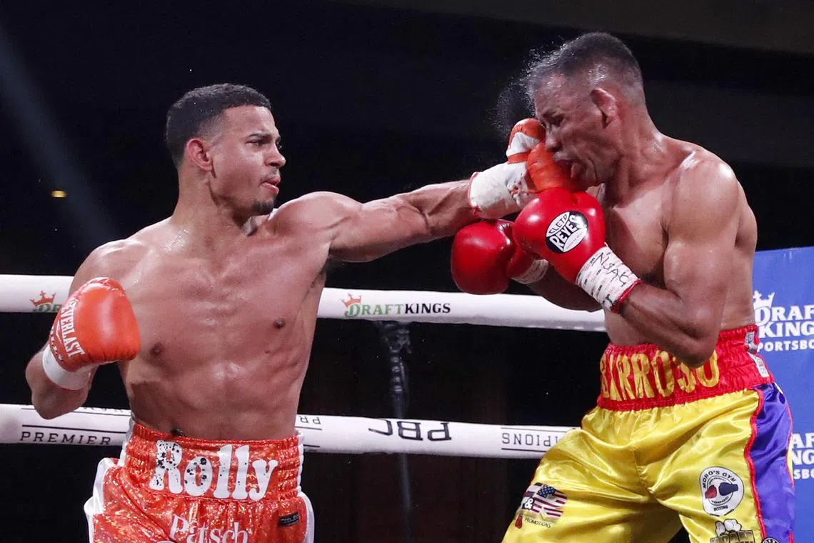 Rolando Romero (left) punching Ismael Barroso in the ninth round of their fight for the vacant WBA super lightweight title at The Cosmopolitan of Las Vegas on Saturday. Romero beat Barroso with a ninth-round TKO to win the vacant title.