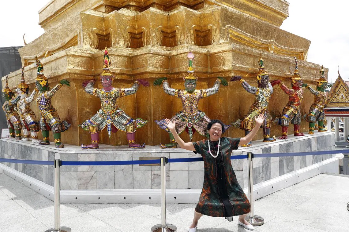 epa10869006 A Chinese tourist poses for a photograph at the Temple of the Emerald Buddha in Bangkok, Thailand 19 September 2023. The Thai government grants the five-month visa exemption scheme for Chinese and Kazakhs tourists effective from 25 September 2023 to 29 February 2024, aiming to generate tourism revenue. Thailand is expected to welcome 1,912,000 to 2,888,500 Chinese tourists during the five-month visa exemption period with the target of 4.04 to 4.4 million Chinese visitors arrival in 2023 to achieve the revenue target of 257,500 million baht (7,155 million US dollars or 6,700 million euro), according to Thapanee Kiatphaibool, Governor of the Tourism Authority of Thailand (TAT). Thailand has achieved 19 million foreign visitors from January to 17 September 2023 showing the sign of tourism industry recovery, the Tourism and Sports Ministry said.  EPA-EFE/RUNGROJ YONGRIT