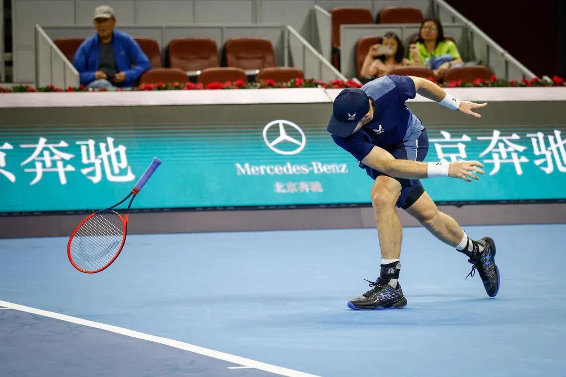 Britain's Andy Murray smashes his racket during his first round match against Alex de Minaur of Australia.