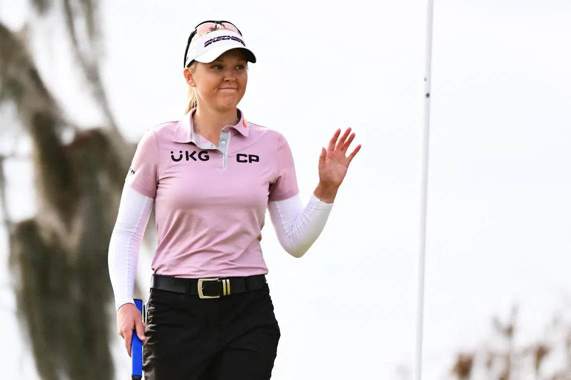 Brooke Henderson of Canada reacts after making her putt on the 18th green during the first round of the Tournament of Champions.