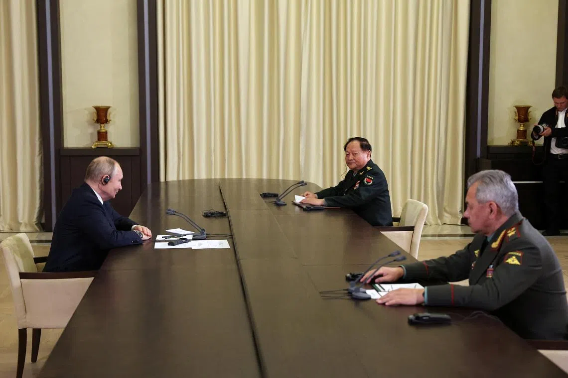 (Clockwise from left) Russian President Vladimir Putin meets vice chairman of China's Central Military Commission General Zhang Youxia and Defence Minister Sergei Shoigu  at the Novo-Ogaryovo state residence, Moscow on Nov 8.