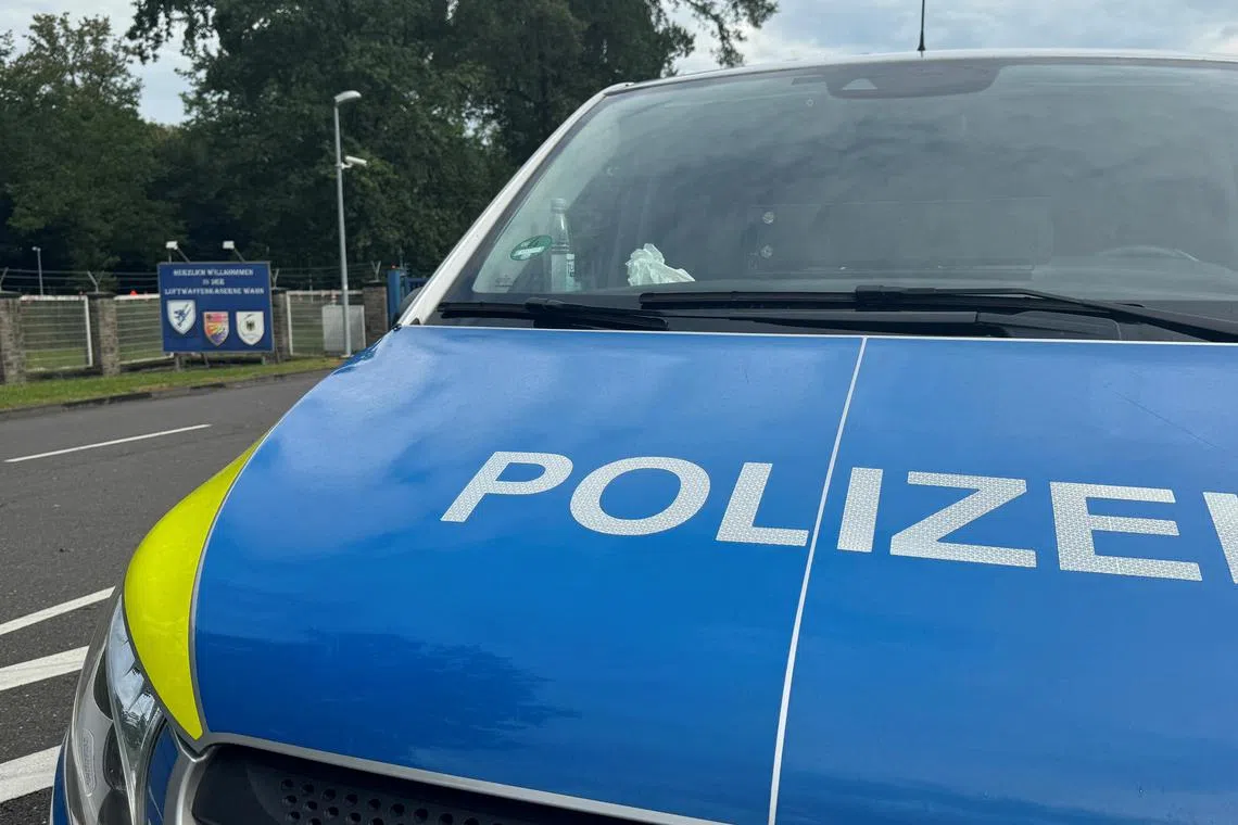 A police car blocks the entrance to the German air force base of Cologne-Wahn, next to Cologne Bonn Airport, after it has been sealed off and the soldiers working there were advised not to drink tap water as authorities investigate what may be an act of sabotage, according to a local media report, in Cologne, Germany, August 14, 2024.   REUTERS/Stephane Nitschke