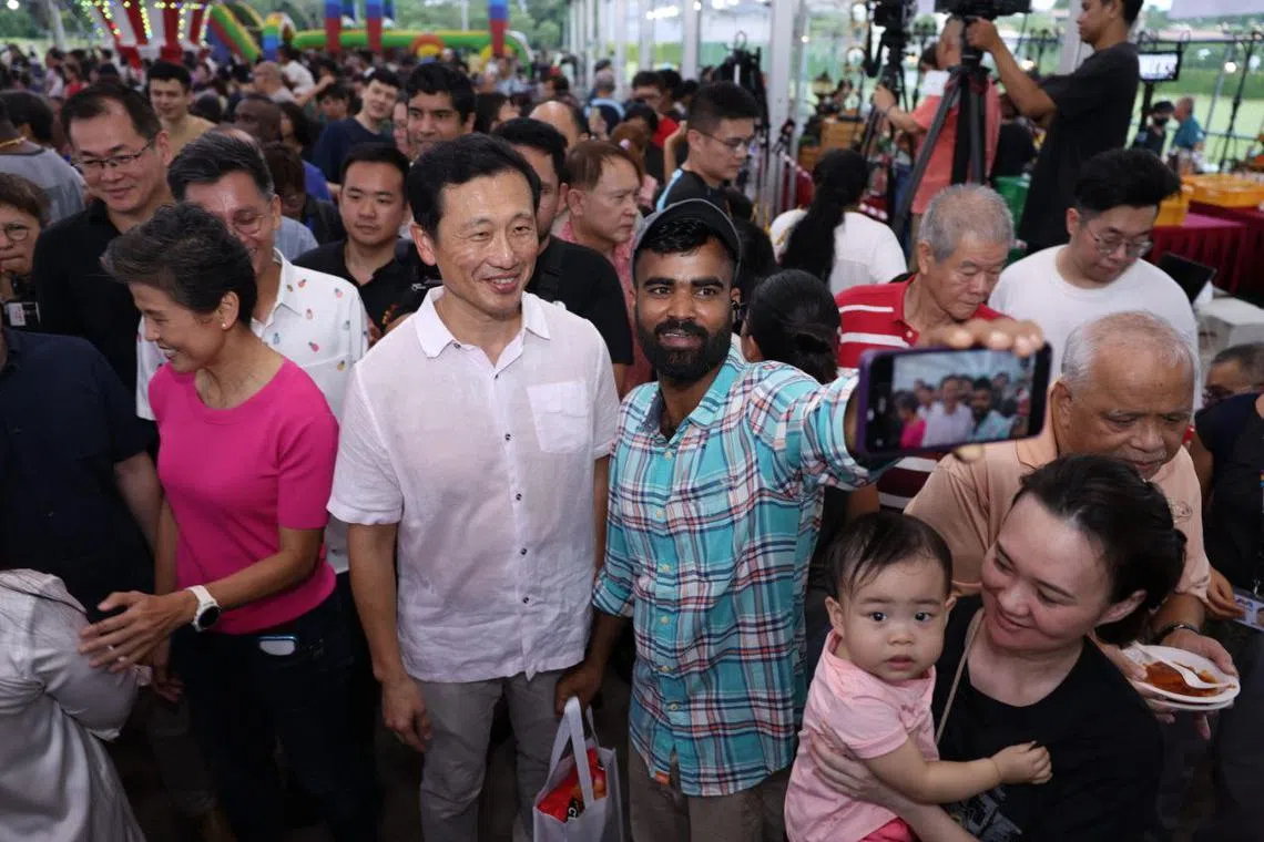 Minister for Health Ong Ye Kung (left) with Sembawang GRC residents at the 'Family Day Carnival @ Sembawang' beside Sun Plaza on April 6.