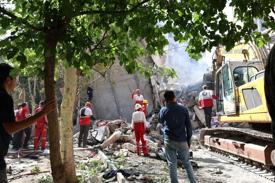 Rescuers working at the site of Israeli air strikes in Tehran, on June 13.