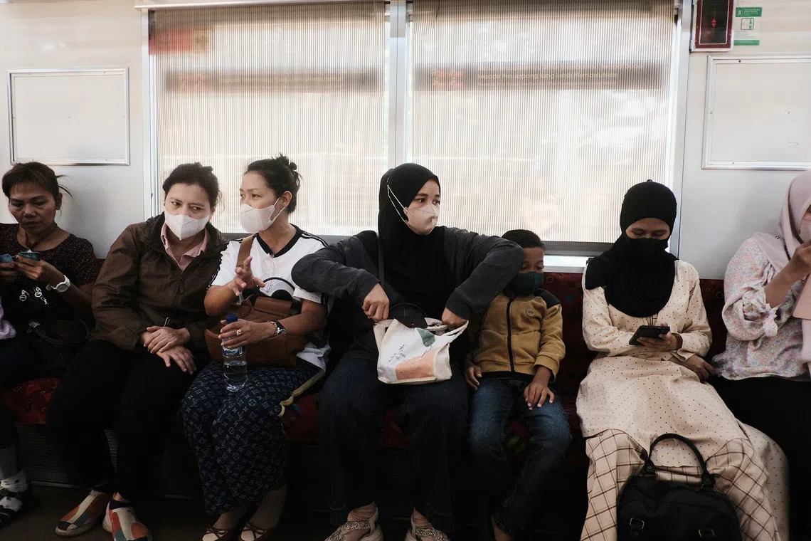 Passengers wearing masks in a commuter line train in Jakarta on Sept 7.