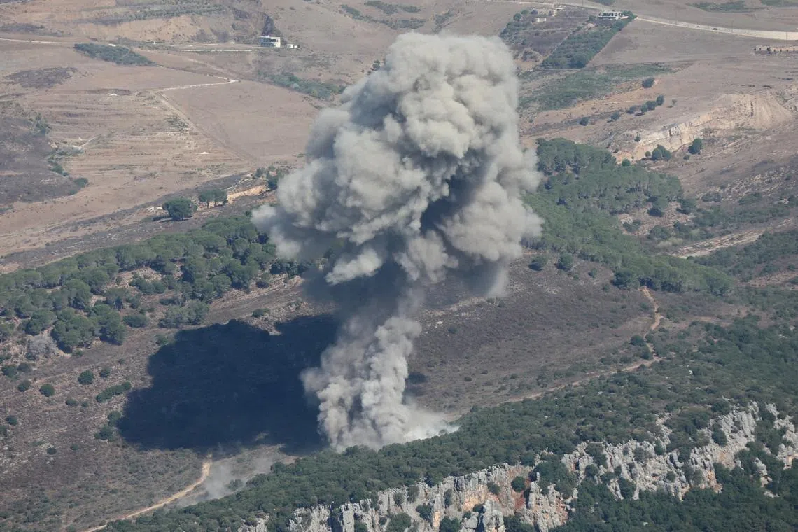 FILE PHOTO: Smoke billows over southern Lebanon, amid ongoing cross-border hostilities between Hezbollah and Israeli forces, as pictured from Marjayoun, near the border with Israel, September 24, 2024. REUTERS/Karamallah Daher/File Photo