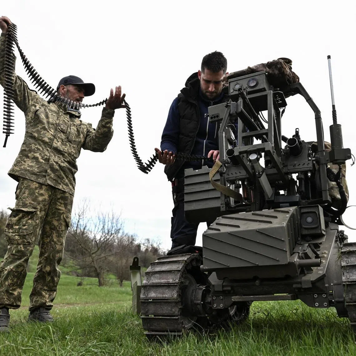 Ukrainian servicemen loading ammunition into an unmanned ground vehicle before testing it, on April 10.