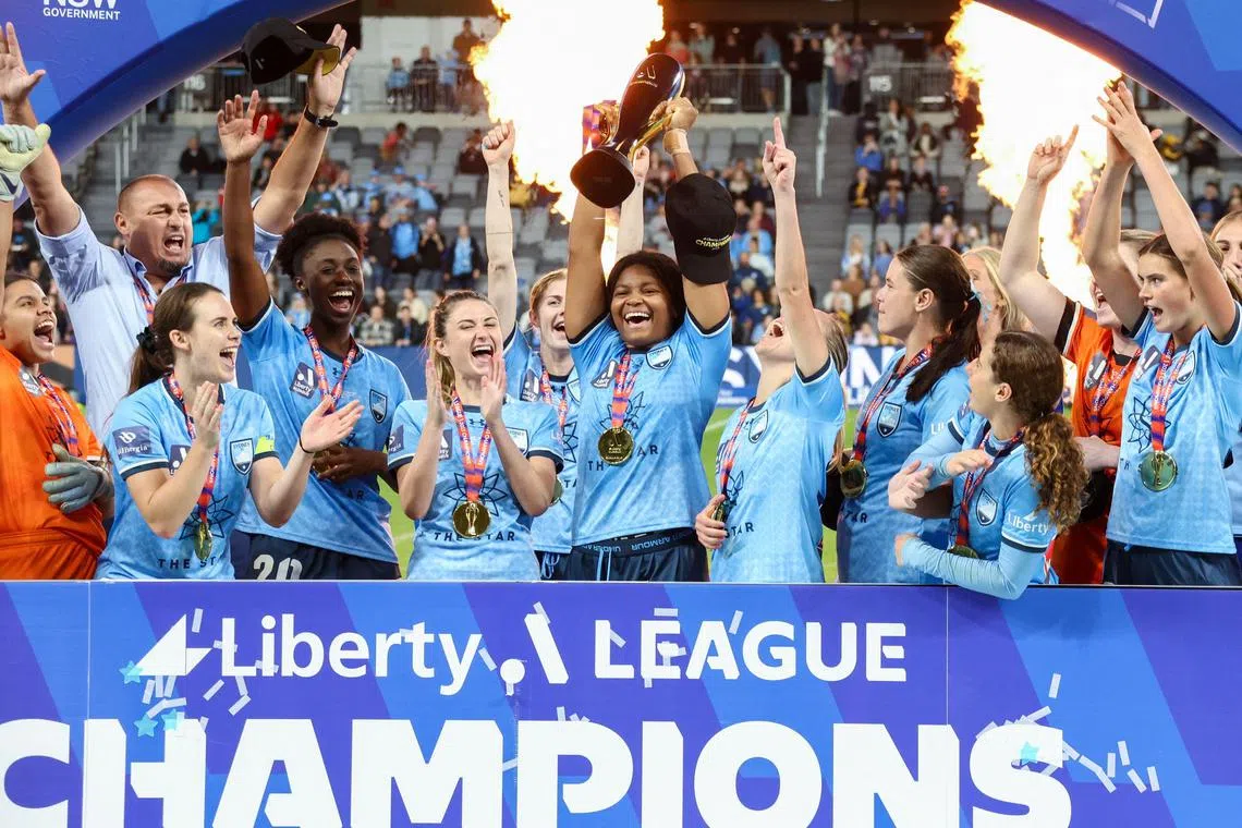 Sydney FC players celebrating with the trophy after winning the women's Liberty A-League Grand Final football match against Western United FC at CommBank Stadium in Sydney on April 30, 2023. 