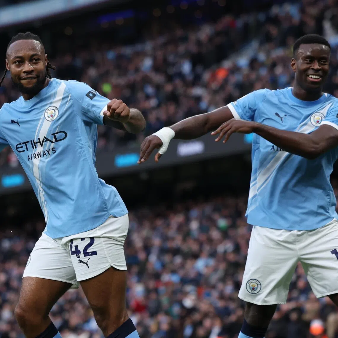 Antoine Semenyo (left) celebrates scoring Manchester City's second goal against Wolves with teammate Marc Guehi.