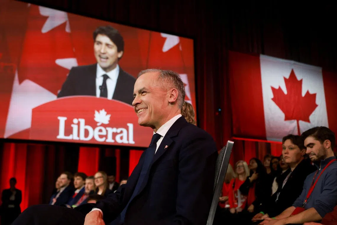 Mark Carney (foreground) succeeds Justin Trudeau (seen on screen) as Canada's prime minister. 