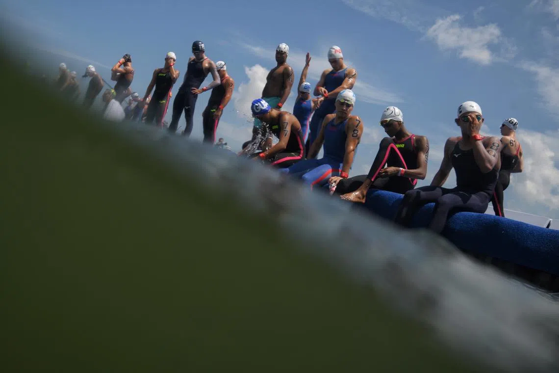 Competitors wait at the start line ahead of the Men's Open Water 10km final held on Sentosa on July 16.