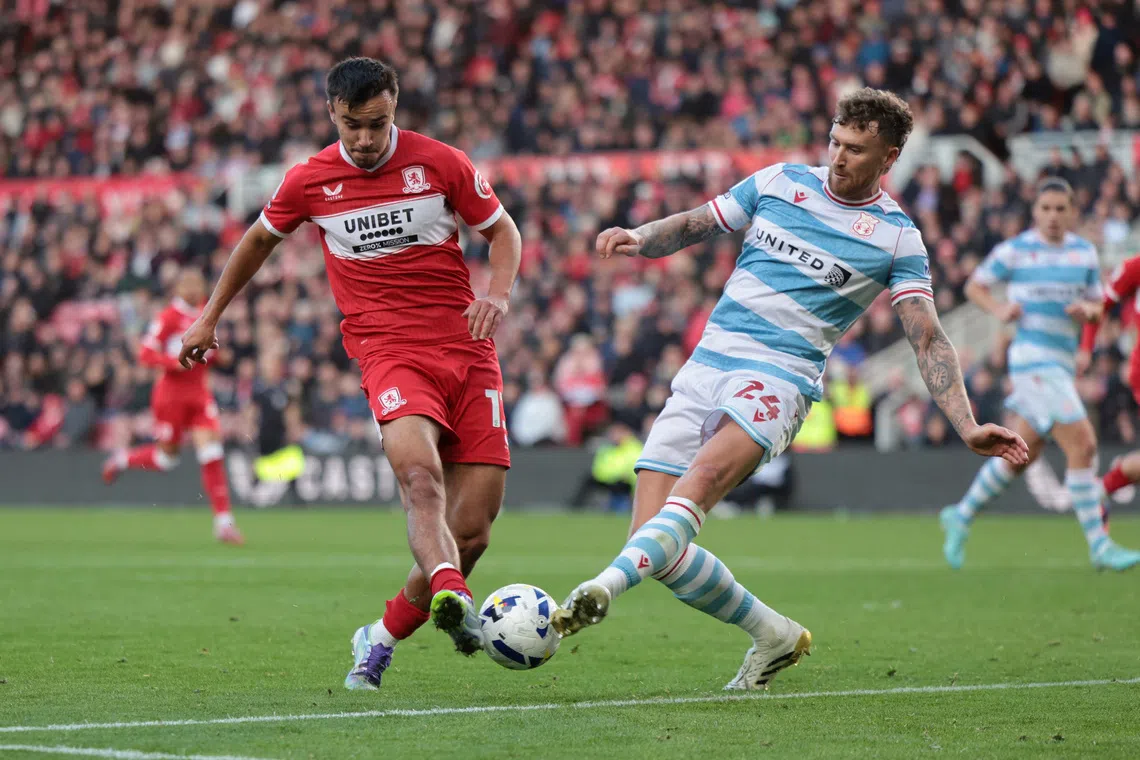 Soccer Football - Championship - Middlesbrough v Wrexham - Riverside Stadium, Middlesbrough, Britain - October 25, 2025 Middlesbrough's David Strelec in action with Wrexham's Dan Scarr Action Images/John Clifton EDITORIAL USE ONLY. NO USE WITH UNAUTHORIZED AUDIO, VIDEO, DATA, FIXTURE LISTS, CLUB/LEAGUE LOGOS OR 'LIVE' SERVICES. ONLINE IN-MATCH USE LIMITED TO 120 IMAGES, NO VIDEO EMULATION. NO USE IN BETTING, GAMES OR SINGLE CLUB/LEAGUE/PLAYER PUBLICATIONS. PLEASE CONTACT YOUR ACCOUNT REPRESENTATIVE FOR FURTHER DETAILS..