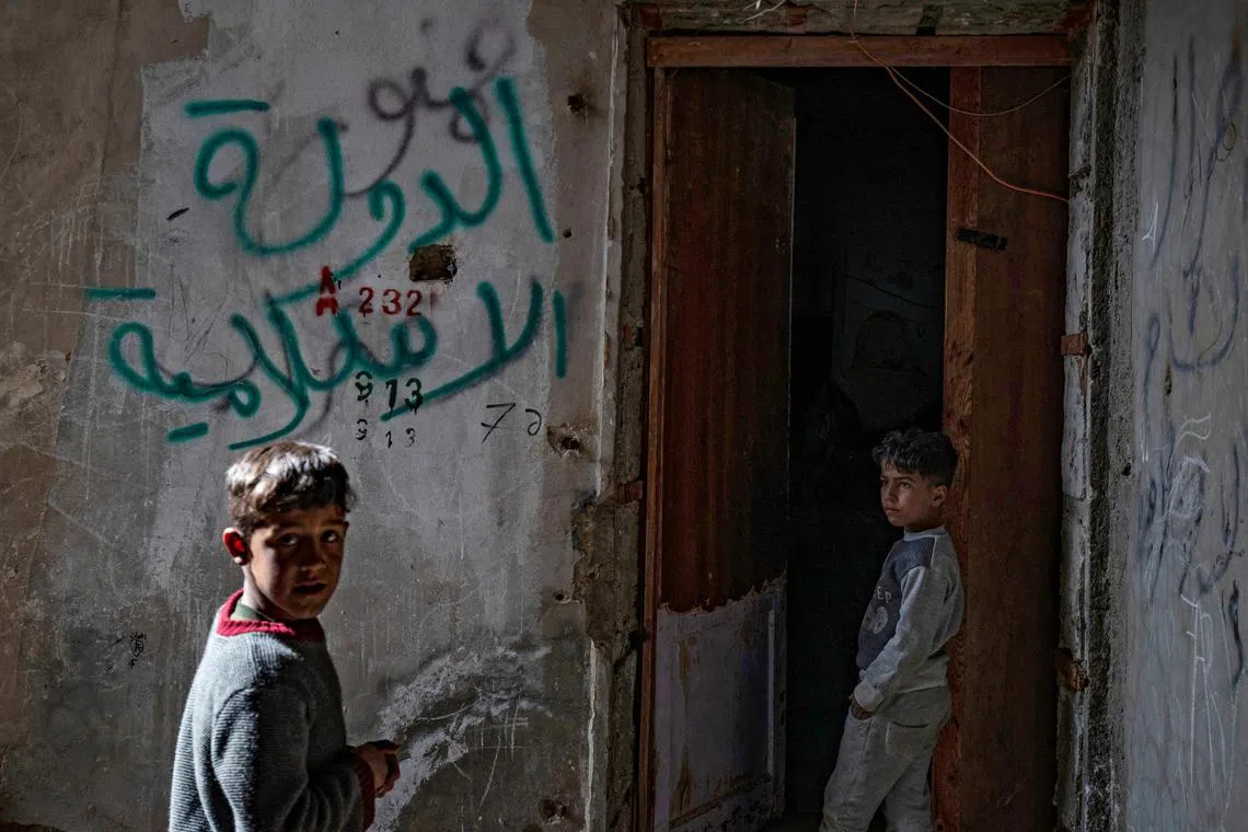 Displaced Syrian children living in war-damaged buildings in Syria's rebel-held northern city of Raqa on March 1, 2023.