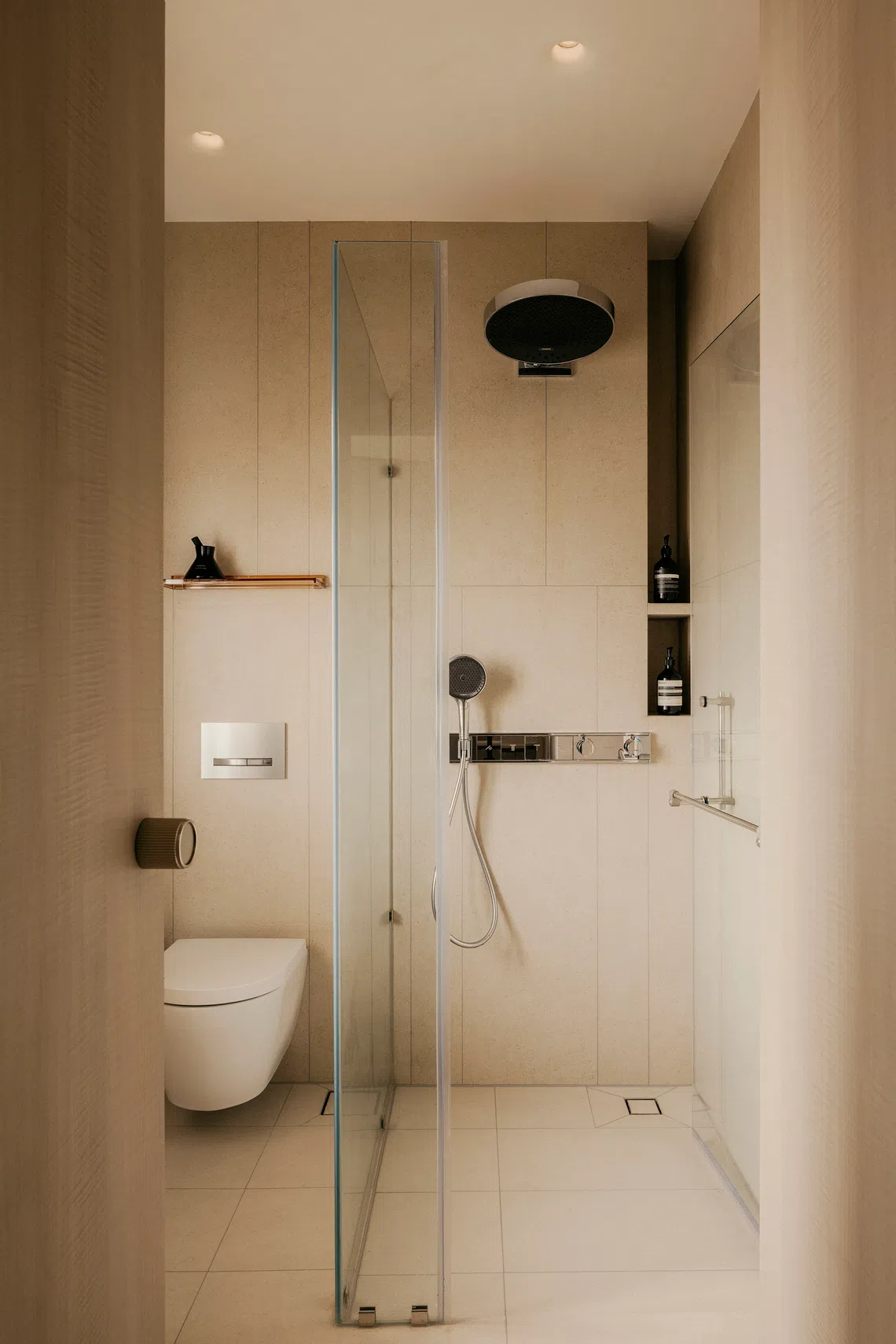 The master bathroom shares its neutral, creamy palette with the rest of the home.