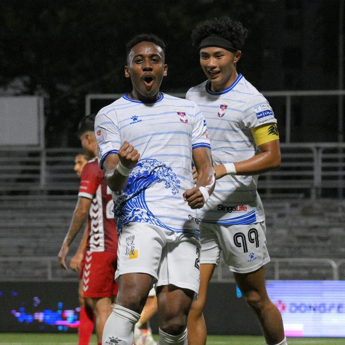 Albirex Niigata striker Abdul Rasaq (left) celebrates with team-mate Shingo Nakano after scoring the opener in the 2-0 Singapore Premier League win over Tanjong Pagar United.