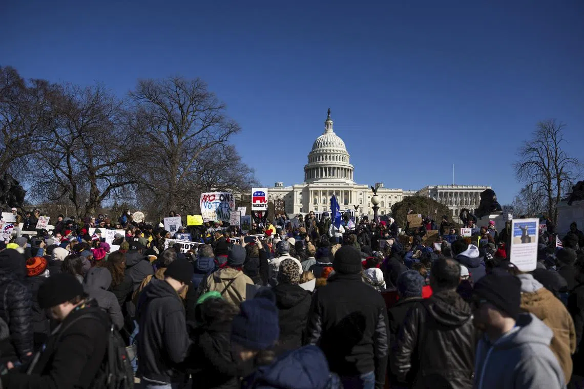 Protesters rallying near the US Capitol in Washington on Feb 17 to denounce the Trump administration.