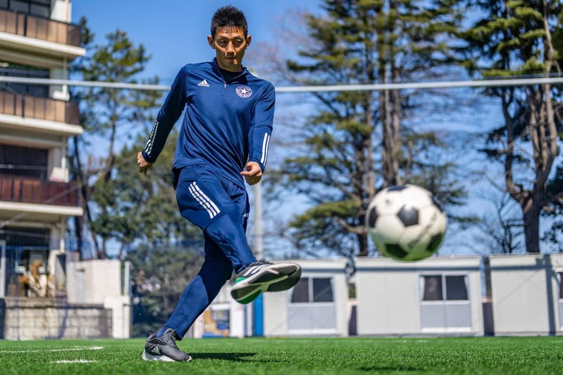 In this picture taken on March 14, 2024, former North Korean football player An Yong Hak poses for photos following an interview by AFP in Yokohama. An Yong Hak was born and raised in Japan but he will be cheering for his former team North Korea when the two sides clash in a World Cup qualifier in Tokyo on March 21.