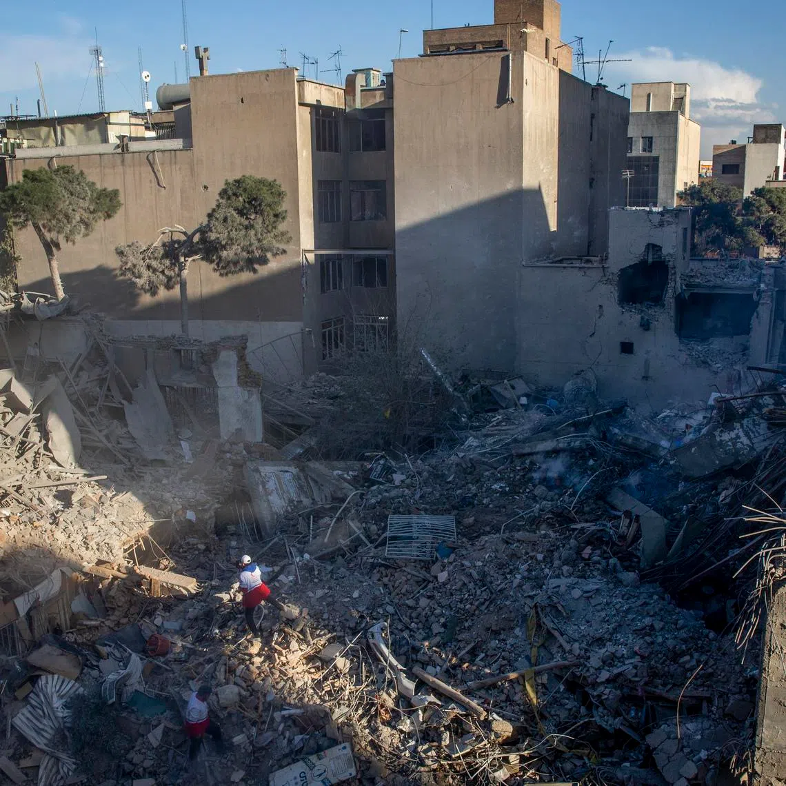 Red Crescent Society workers clear debris from a synagogue destroyed in US-Israeli airstrikes in Tehran on April 7.
