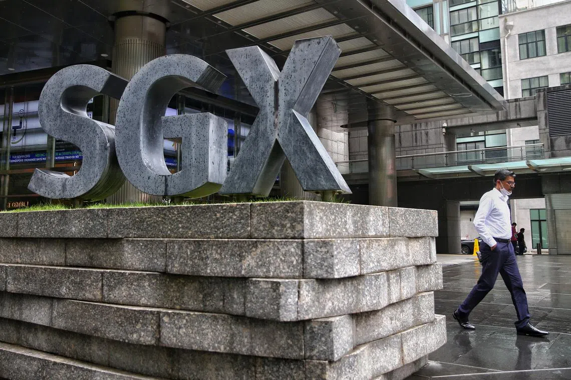 A man walks past the SGX building in the central business district (CBD) of Singapore, 20 June 2022.