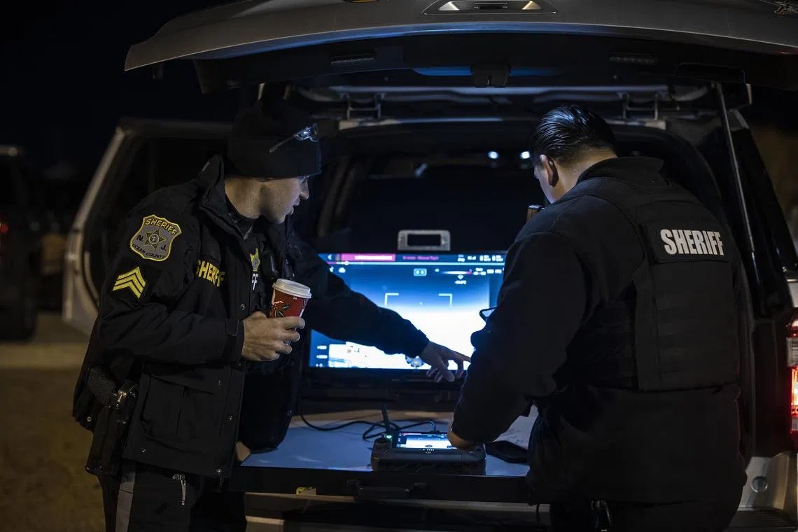 Sgt. John Frassetto, left, and Detective Anthony D'Amico use a drone to monitor any nearby drone activity in Seaside Heights, N.J., on Dec. 13, 2024. In the Garden State, where the rash of sightings started a month ago, residents are looking to the skies, wondering why they still don’t have definitive answers from officials. (Dave Sanders/The New York Times)