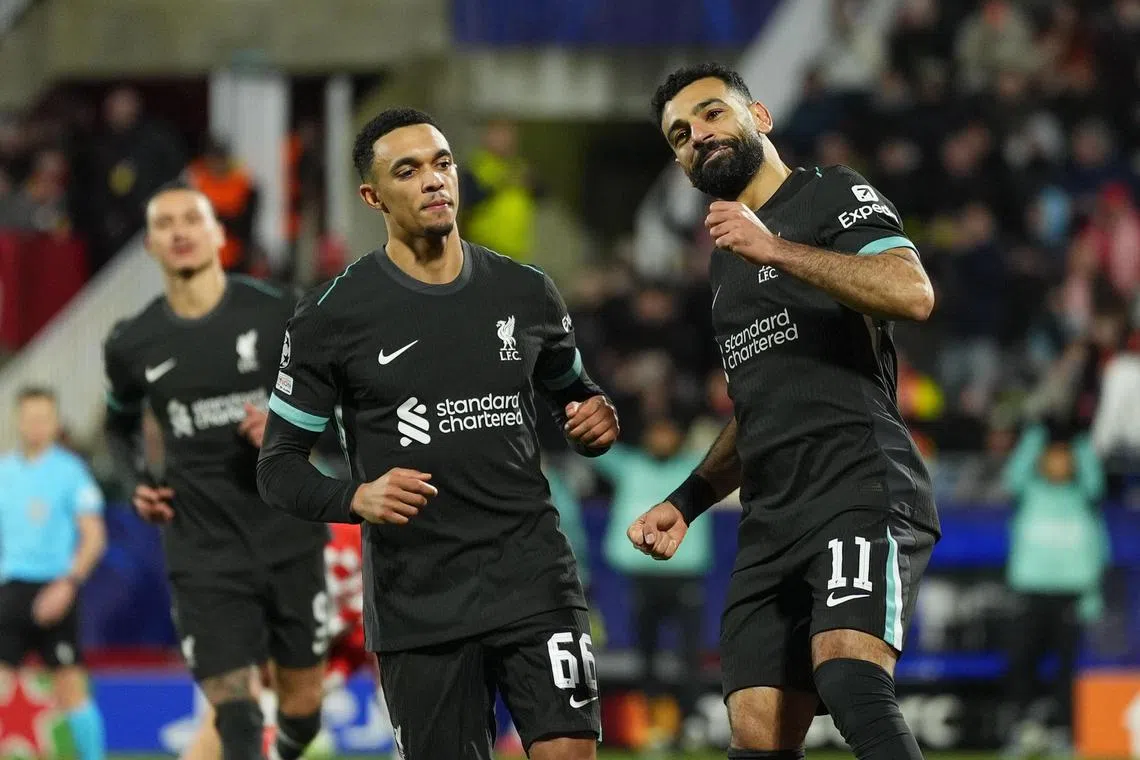 Liverpool's Mohamed Salah (right) celebrates after scoring the only goal of the match from the penalty spot.