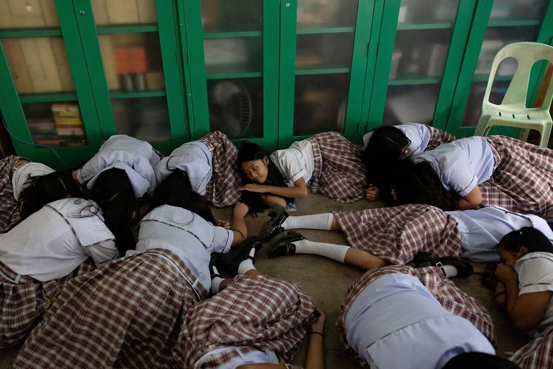 Students take cover during an active-shooter drill following recent school shootings in the country, at Carlos F. Gonzales High School in San Rafael, Bulacan, Philippines, September 3, 2026. REUTERS/Eloisa Lopez TPX IMAGES OF THE DAY