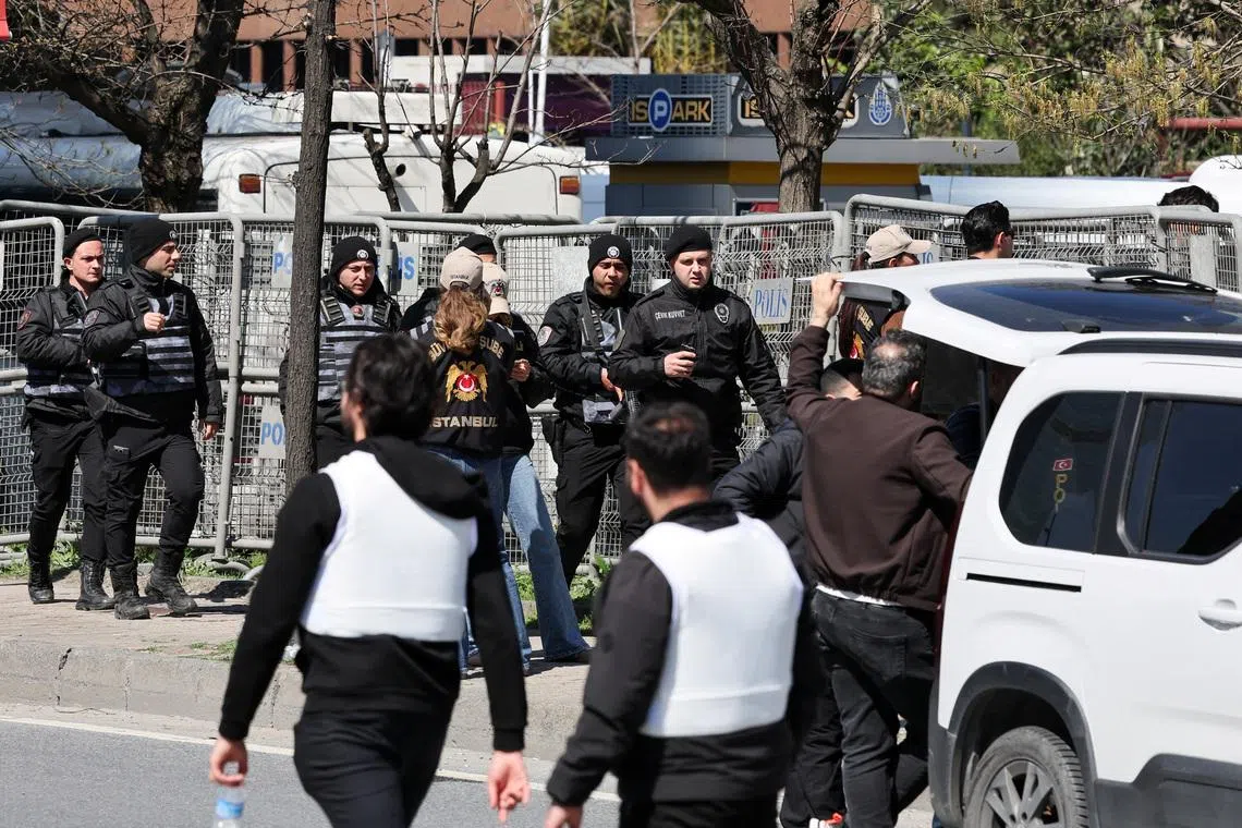 Police officers walk near the scene, after a gunfire was heard near the building housing the Israeli consulate, according to a witness, in Istanbul, Turkey, April 7, 2026. REUTERS/Umit Bektas