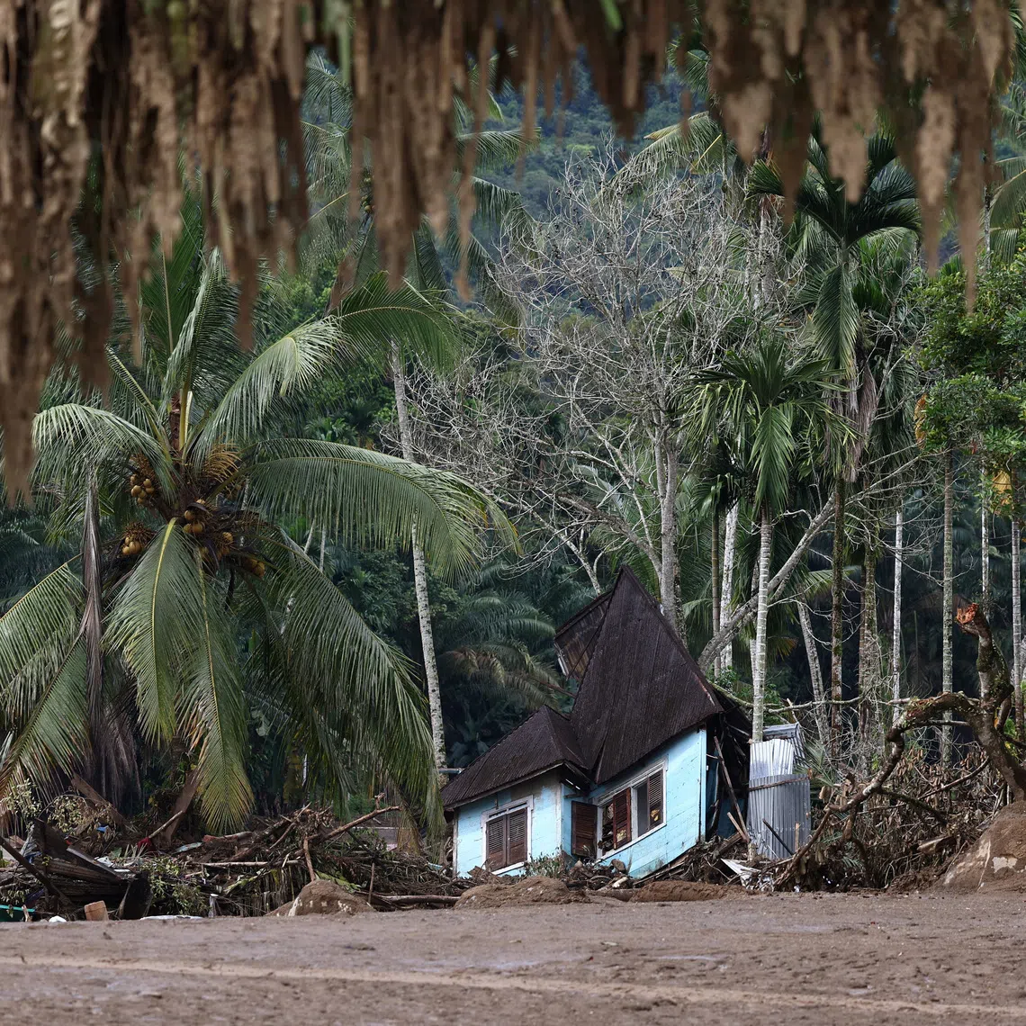 A heavily damaged house sits among debris in an area hit by deadly flash floods following heavy rains in Palembayan, Agam regency, West Sumatra province, Indonesia, December 2, 2025. REUTERS/Willy Kurniawan