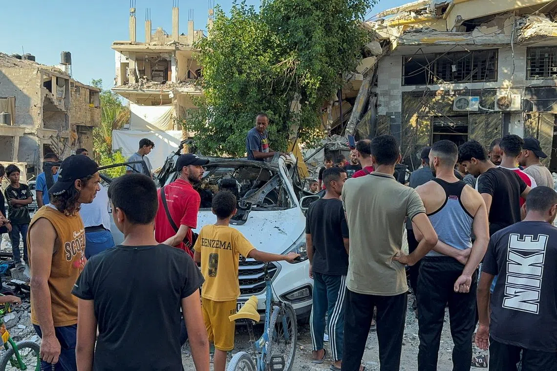 Palestinians inspect a vehicle where Al Jazeera TV said its reporter Ismail al-Ghoul and cameraman Ramy El Rify were killed in an Israeli strike, in Gaza City July 31, 2024. REUTERS/Ayman Al Hassi