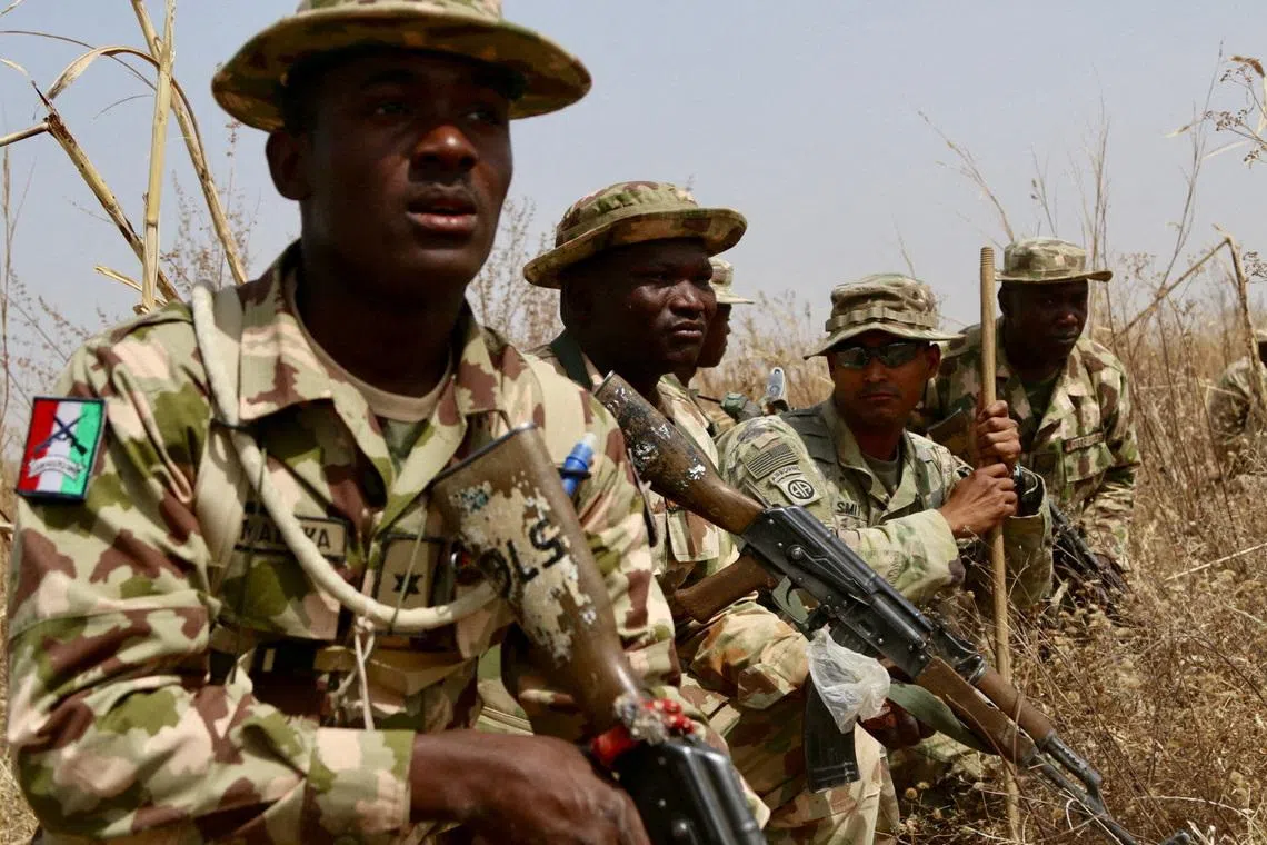 FILE PHOTO: A U.S. Army soldier (2R) trains Nigerian Army soldiers at a military compound in Jaji, Nigeria, February 14, 2018.    Capt. James Sheehan/U.S. Army/Handout via REUTERS/File Photo