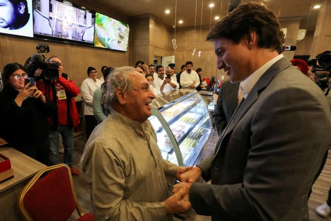 FILE PHOTO: Canada's Prime Minister Justin Trudeau greets a person as he visits the Maharaja sweet shop in Surrey, British Columbia, Canada, November 14, 2023. REUTERS/Chris Helgren/File Photo