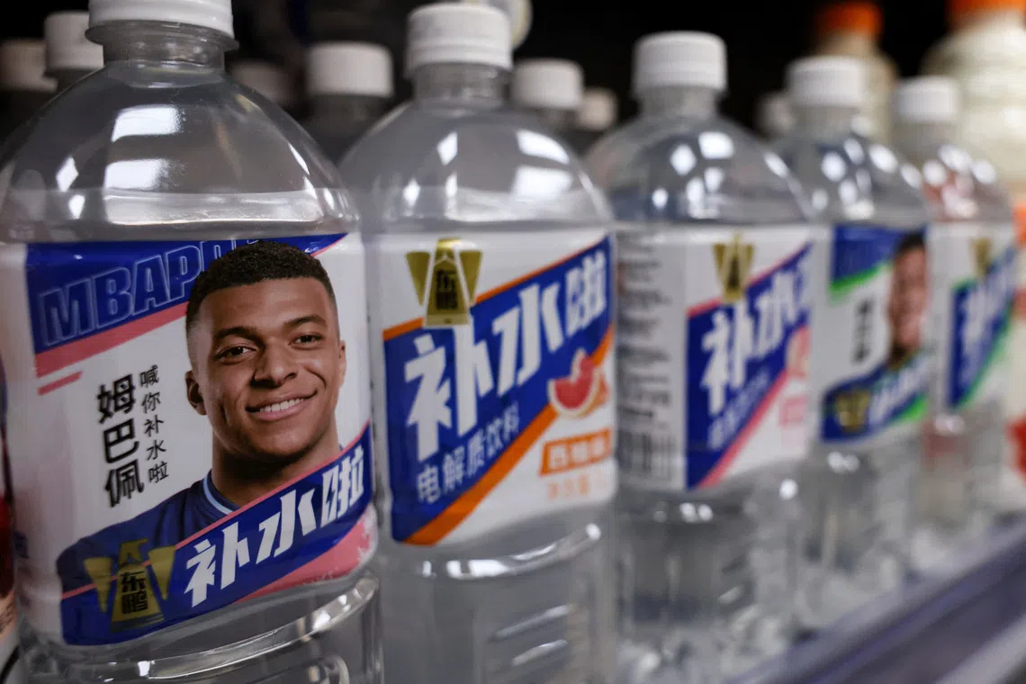Bottled drinks by Eastroc Beverage with images of French soccer player Kylian Mbappe are displayed on a shelf at a store, in Beijing, China October 27, 2026. REUTERS/Tingshu Wang