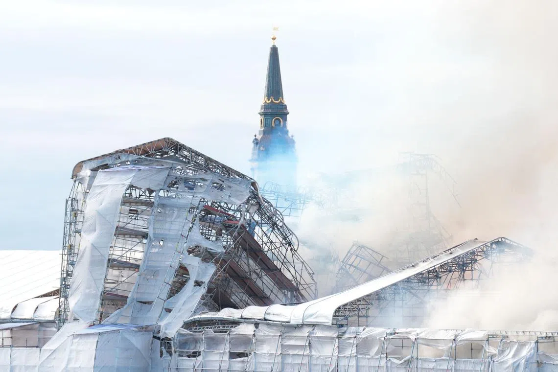 Plumes of smoke billowing from the historic Boersen stock exchange building which was on fire in central Copenhagen, Denmark, on April 16, 2024. 