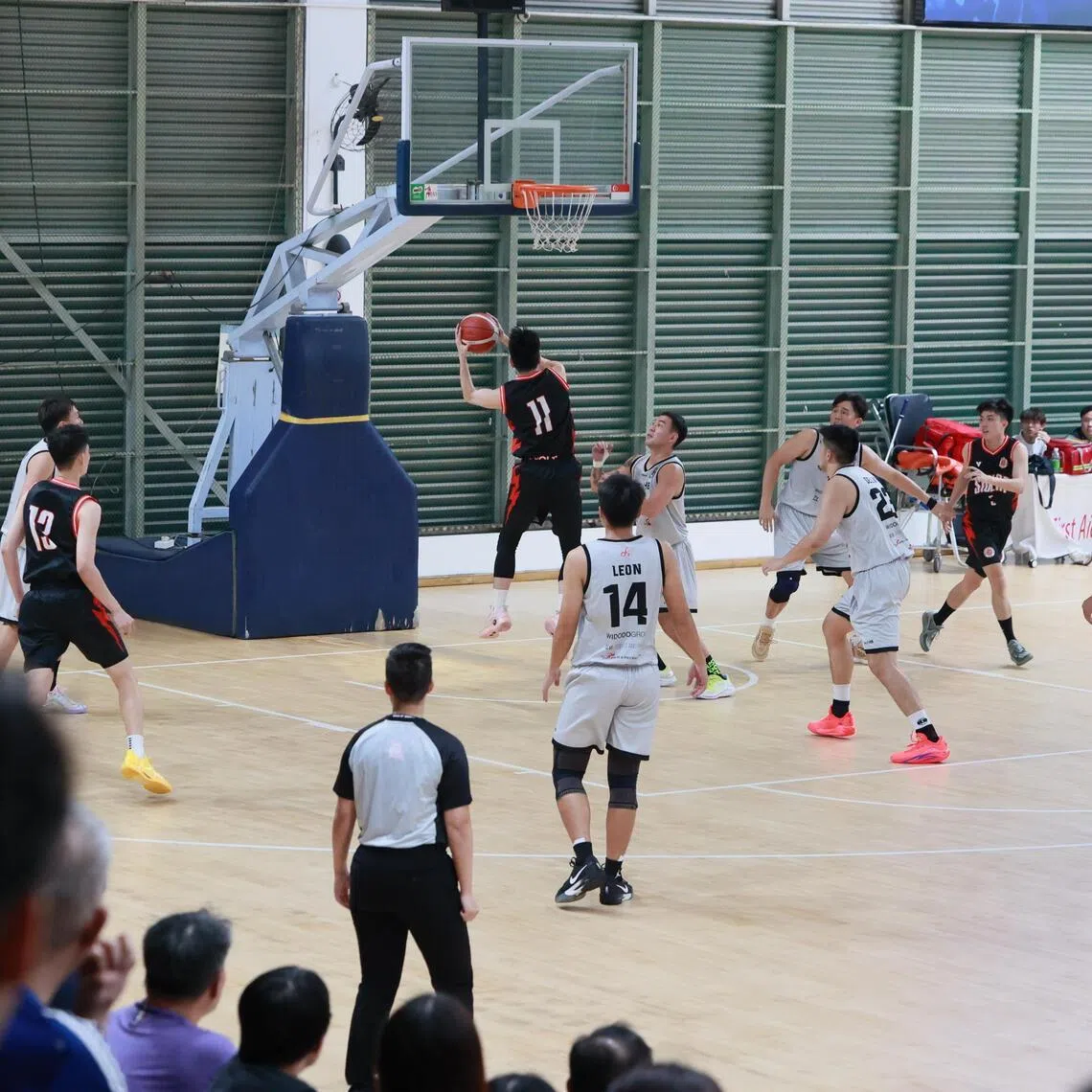 Adroit HB (in white) playing Siglap Basketball Club in a National Basketball League Division 1 semi-final clash on Aug 27, 2025. Adroit won 67-52, but were later disqualified for fielding two players under investigation for match-fixing.