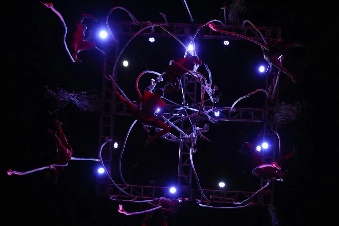 Actors hang from a crane during the Christmas show called "The tree of abundance" in the Plaza de Bolivar in Bogota, Colombia December 14, 2022. 