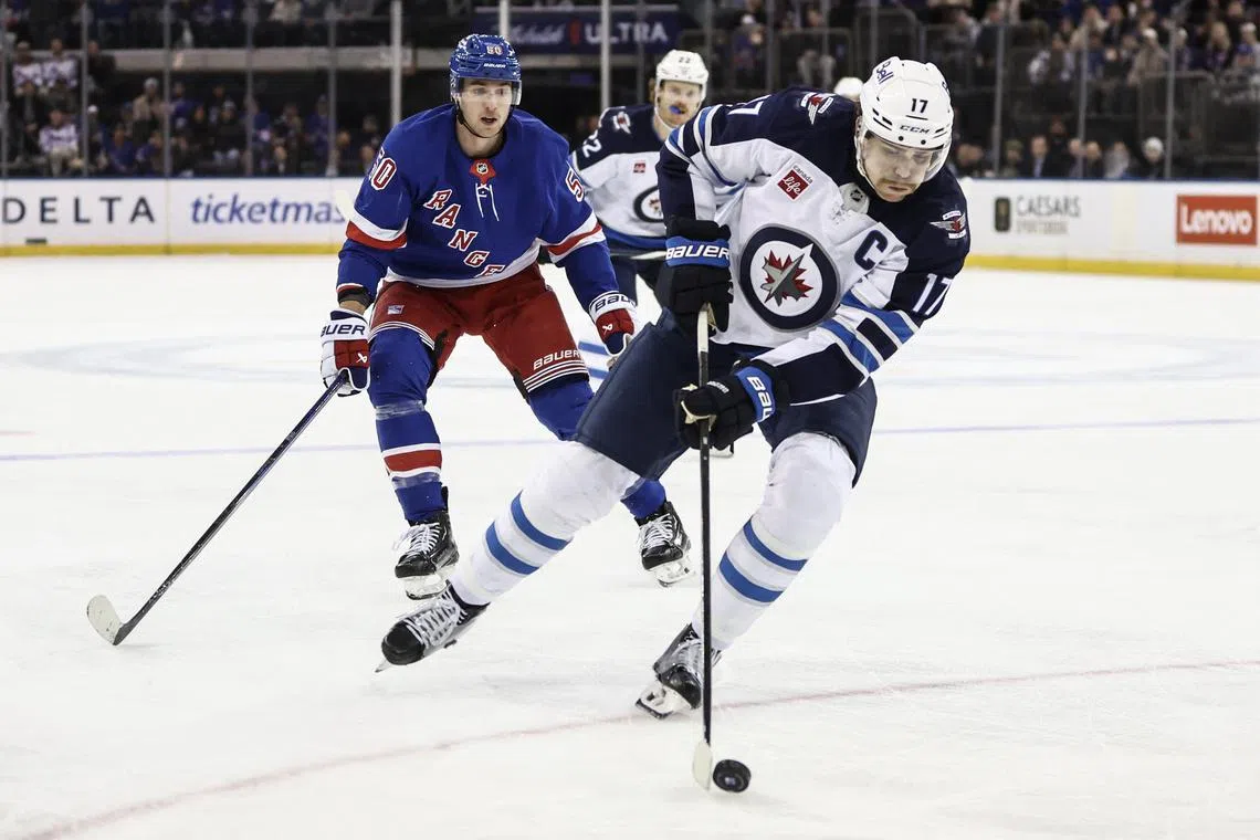 FILE PHOTO: Nov 12, 2024; New York, New York, USA;  Winnipeg Jets center Adam Lowry (17) controls the puck in the third period against the New York Rangers at Madison Square Garden. Mandatory Credit: Wendell Cruz-Imagn Images/File Photo