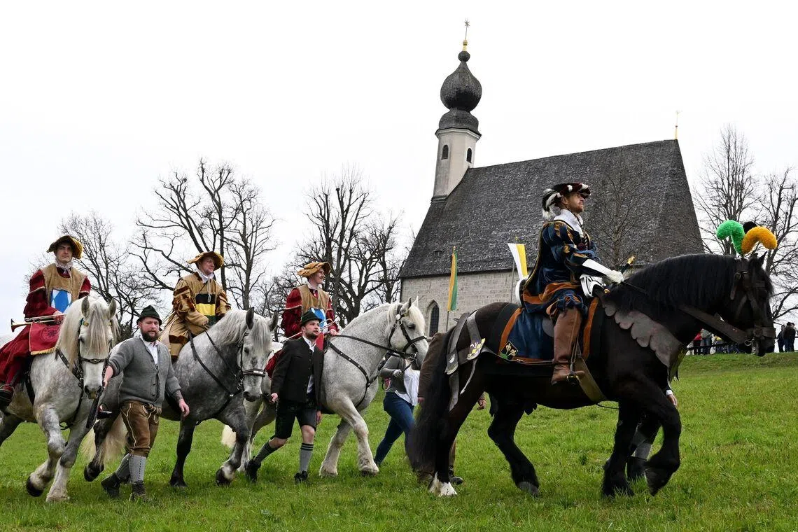 Participants in historical costumes, on horseback are seen during the traditional St George's Cavalcade (Georgiritt) in Traunstein, southern Germany on Easter Monday, on April 6, 2026. 