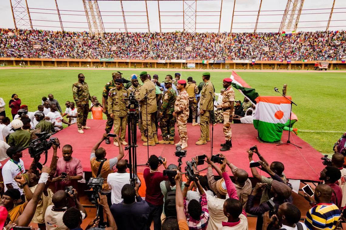 Supporters of Niger's coup leaders take part in a rally at a stadium in Niamey, Niger, on Aug 6.