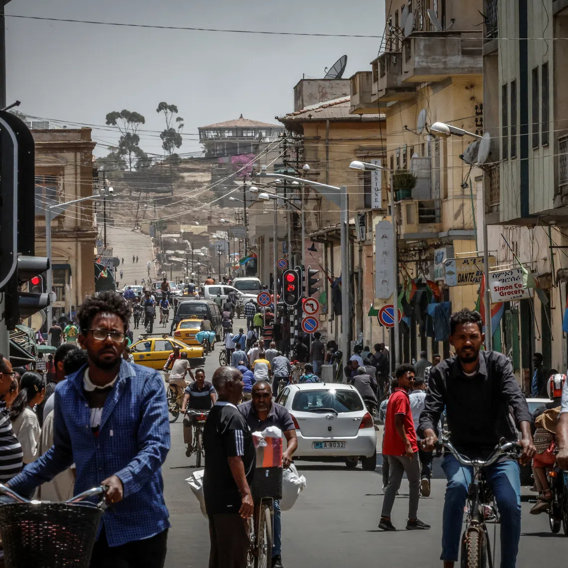People walk and ride bicycles on a busy street in downtown Asmara, Eritrea, June 19, 2026. Eritrea has long been isolated by the West, which views the East African country as among the most repressive in the world, while the government in Asmara has itself pursued a policy of political and economic seclusion. Despite its small population, Eritrea has gained new geopolitical importance this year, during the Iran war, because of its 1,000-km Red Sea coastline along a key shipping route between the Mediterranean and Asia. As conflict disrupted traffic through the Strait of Hormuz and attacks by Iran-backed Houthi militants threatened vessels near Yemen, Eritrean waters emerged as potentially one of the safest corridors for maritime trade. REUTERS/Monicah Mwangi