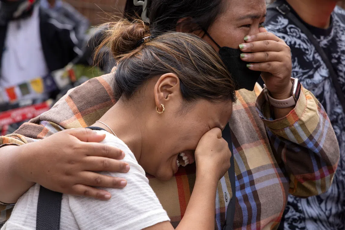 Relatives of victims and missing people weep outside the morgue of the Tribhuvan University Teaching Hospital in Kathmandu on Aug 29.