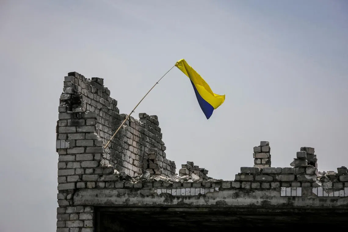 A Ukrainian national flag is seen in the newly liberated village of Neskuchne, in Ukraine's Donetsk region.