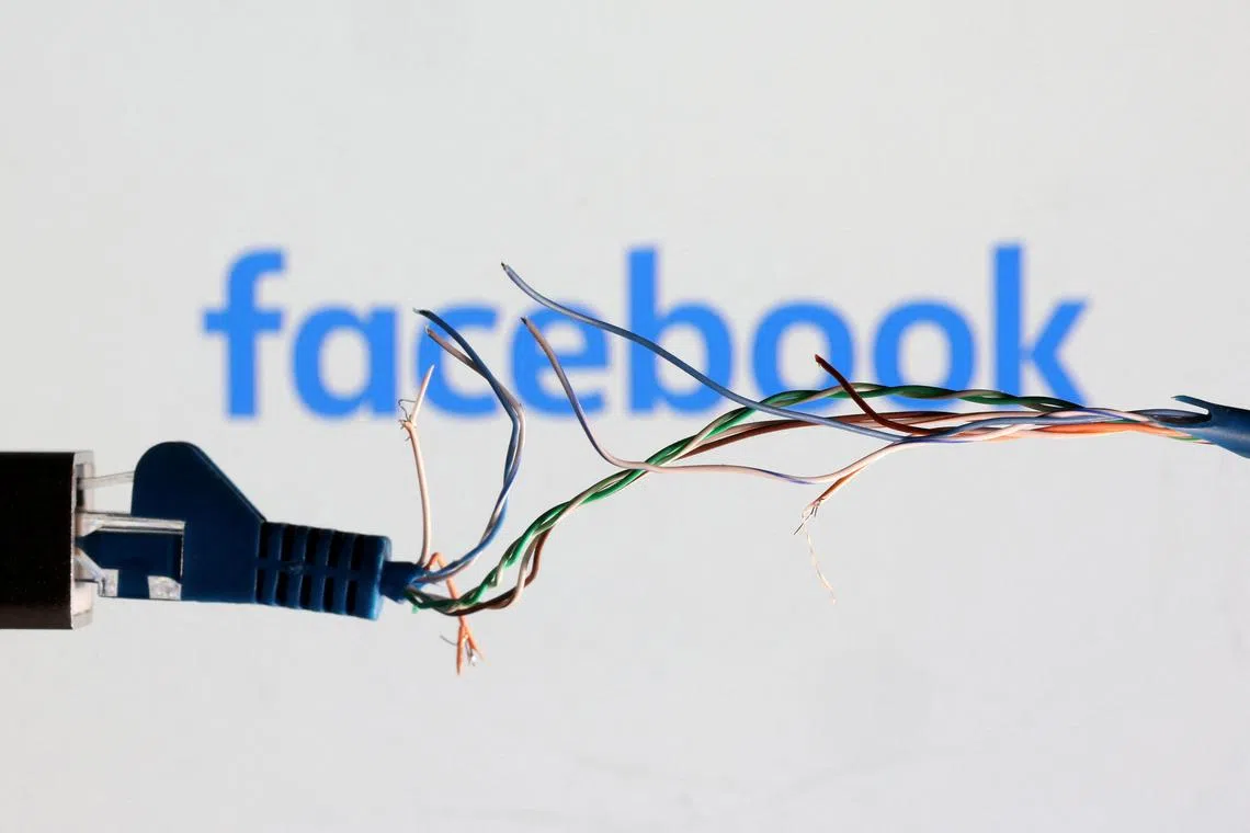 FILE PHOTO: Broken Ethernet cable is seen in front of Facebook logo in this illustration taken March 11, 2022. REUTERS/Dado Ruvic/Illustration/File Photo