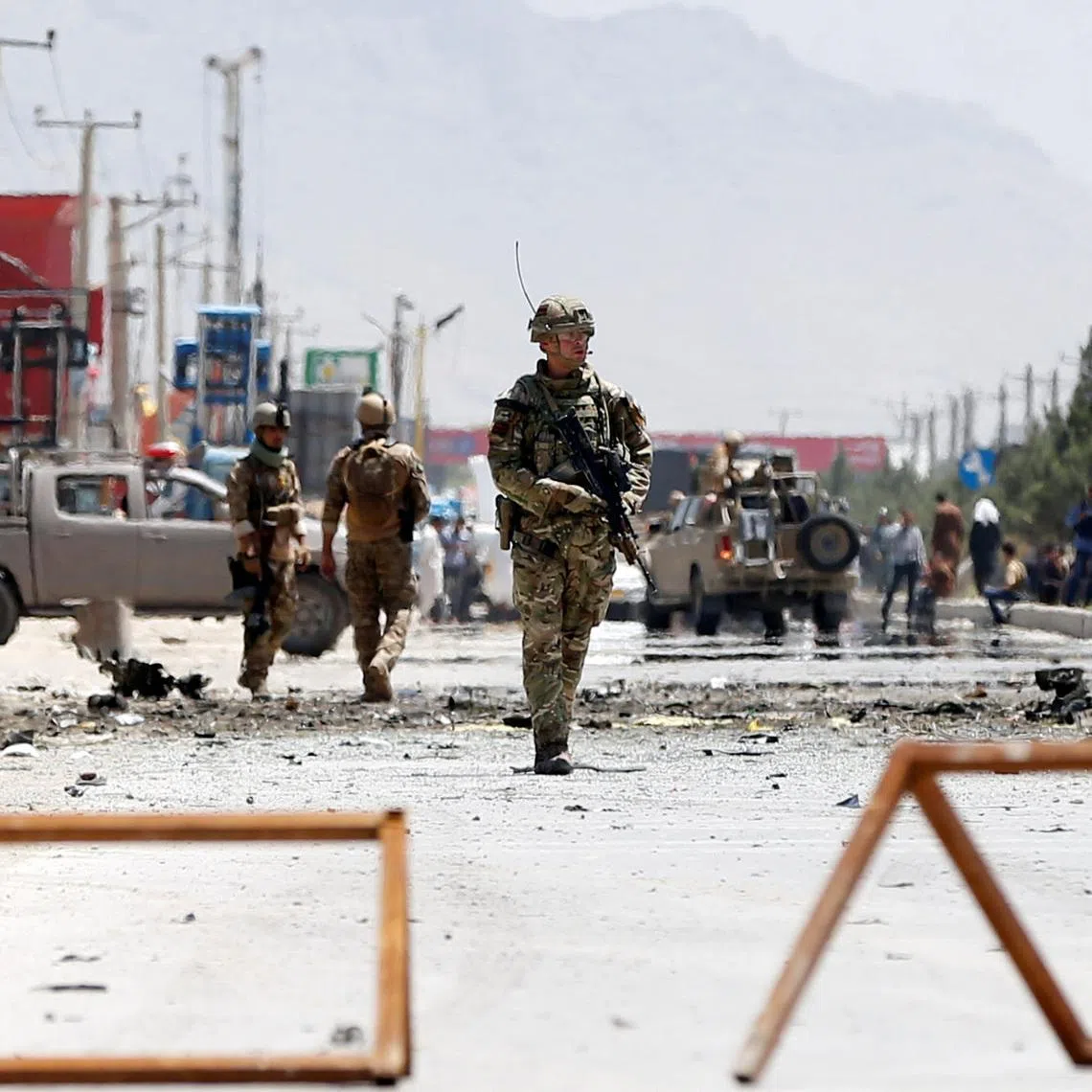 Afghan security forces and a British soldier with NATO-led Resolute Support Mission stand guard at the site of a suicide attack in Kabul, Afghanistan May 31, 2019. REUTERS/Omar Sobhani