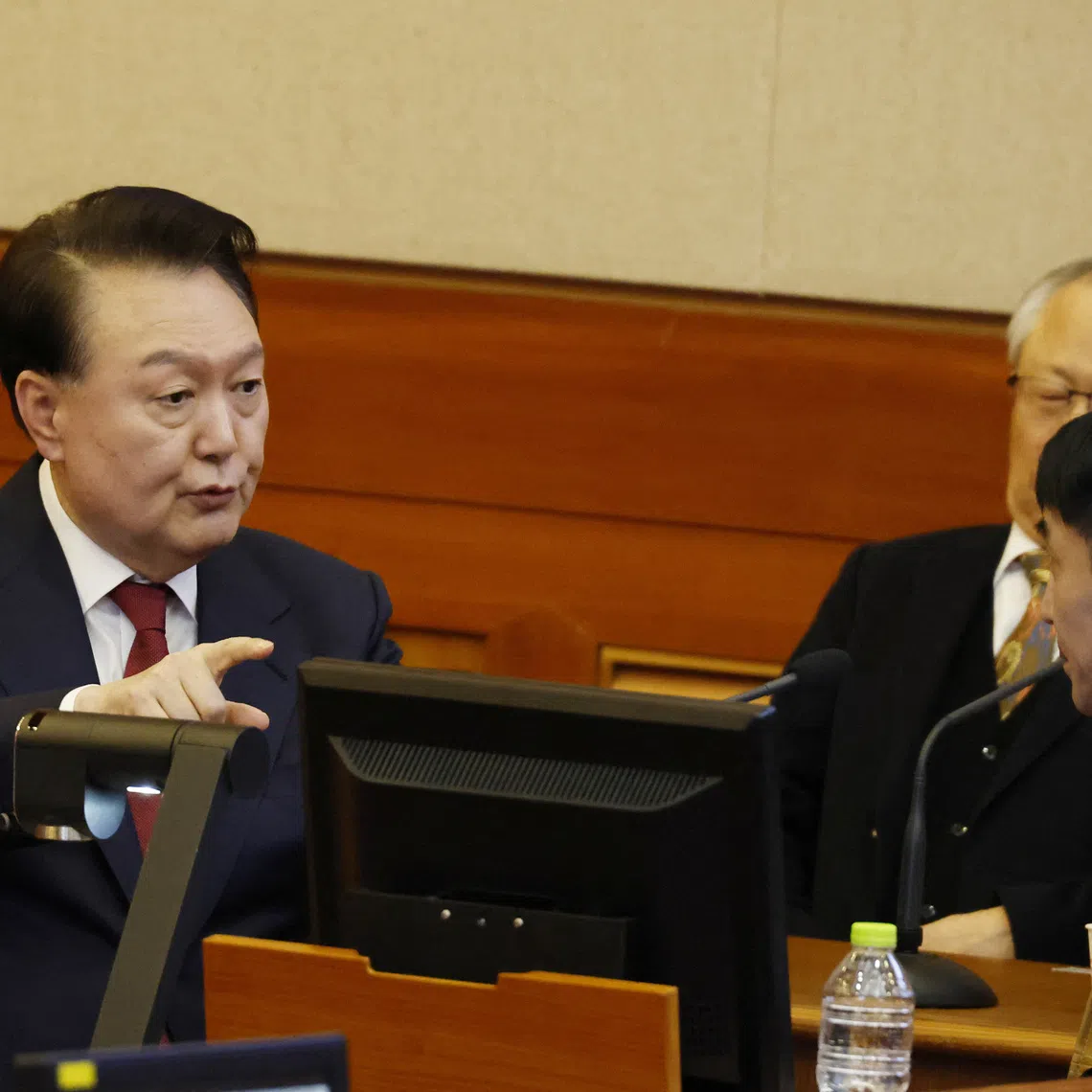 South Korea’s impeached President Yoon Suk Yeol speaks to his lawyers as he attends the fourth hearing of his impeachment trial over his short-lived imposition of martial law at the Constitutional Court in Seoul, South Korea, 23 January 2025.    JEON HEON-KYUN/Pool via REUTERS