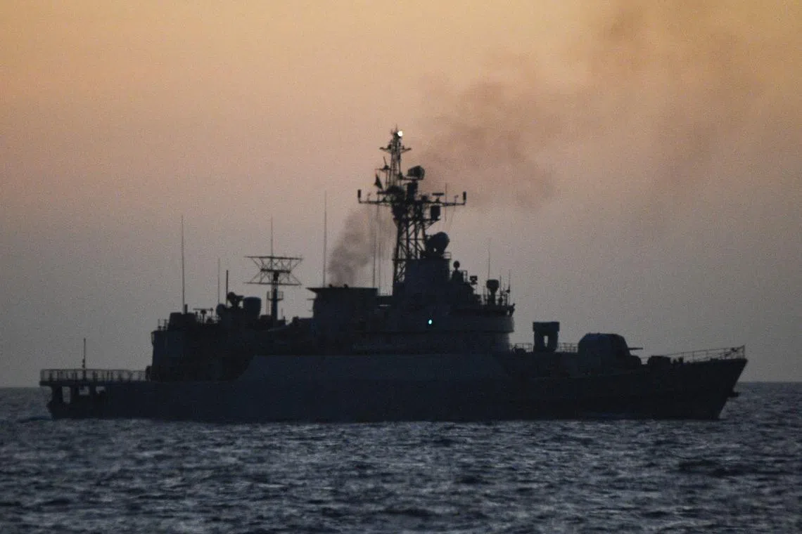 This photo taken on Feb 15, 2024 shows a Chinese navy ship shadowing a Philippine Bureau of Fisheries and Aquatic Resources boat (not pictured) near the China-controlled Scarborough Shoal, in disputed waters of the South China Sea. 
