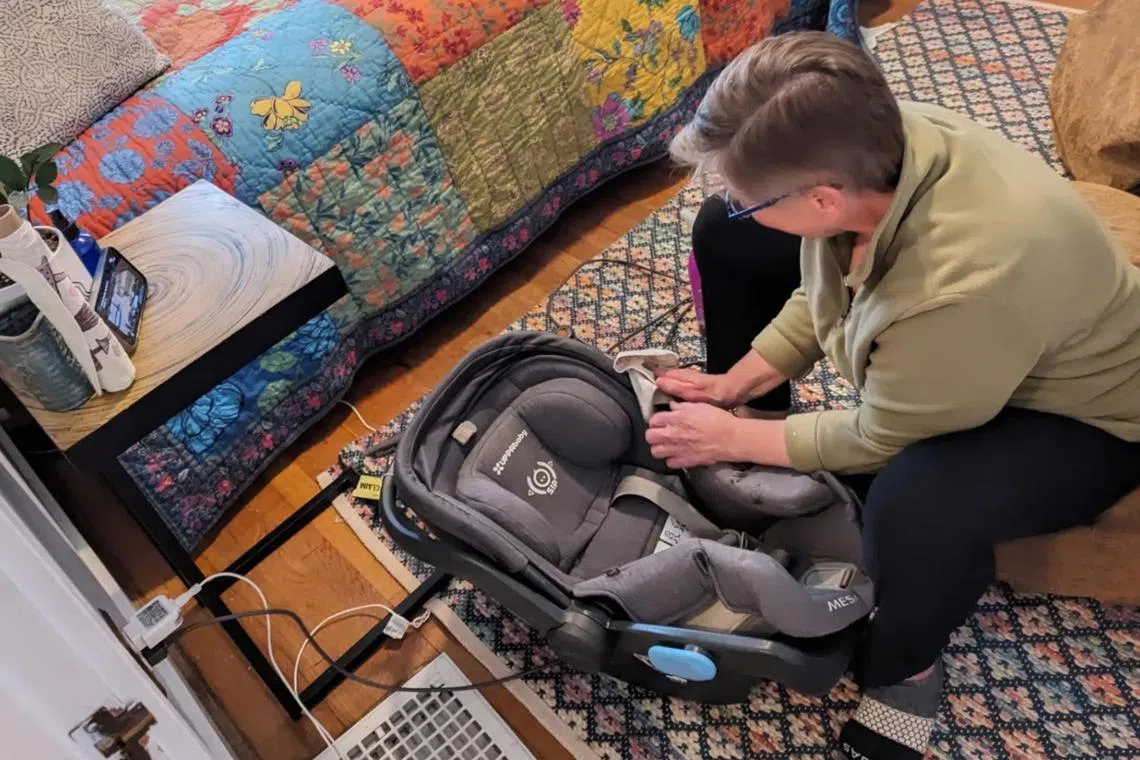 In an undated image provided via Greta Seidohl, a neighbour cleans a car seat for Greta Seidhol. 