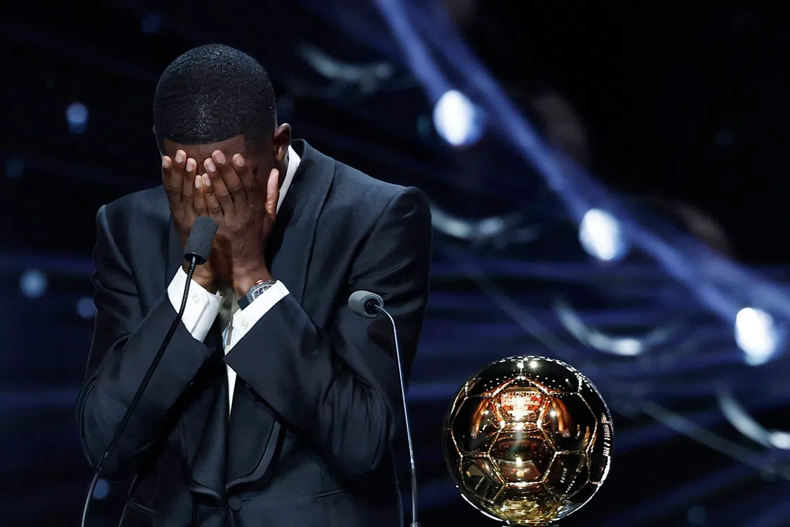 Soccer Football - Ballon d'Or - Theatre du Chatelet, Paris, France - September 22, 2025 Paris St Germain's Ousmane Dembele celebrates after winning the men's Ballon d'Or award REUTERS/Benoit Tessier