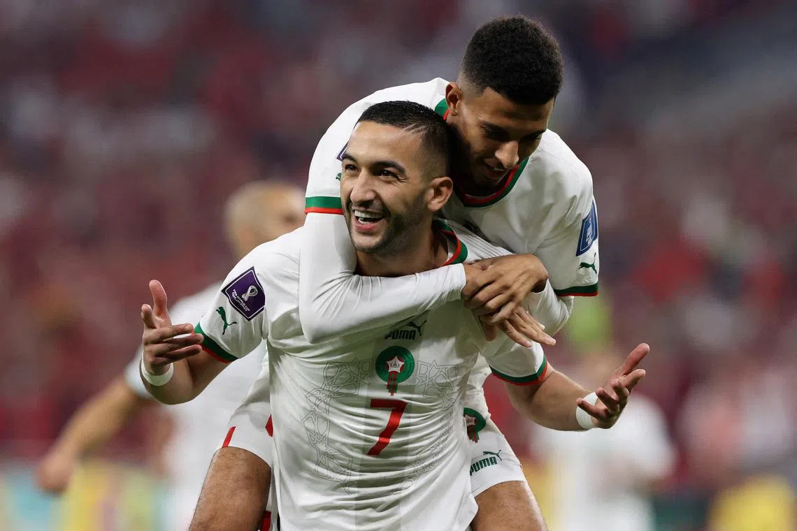 Morocco's Hakim Ziyech celebrates scoring their first goal with Azzedine Ounahi.