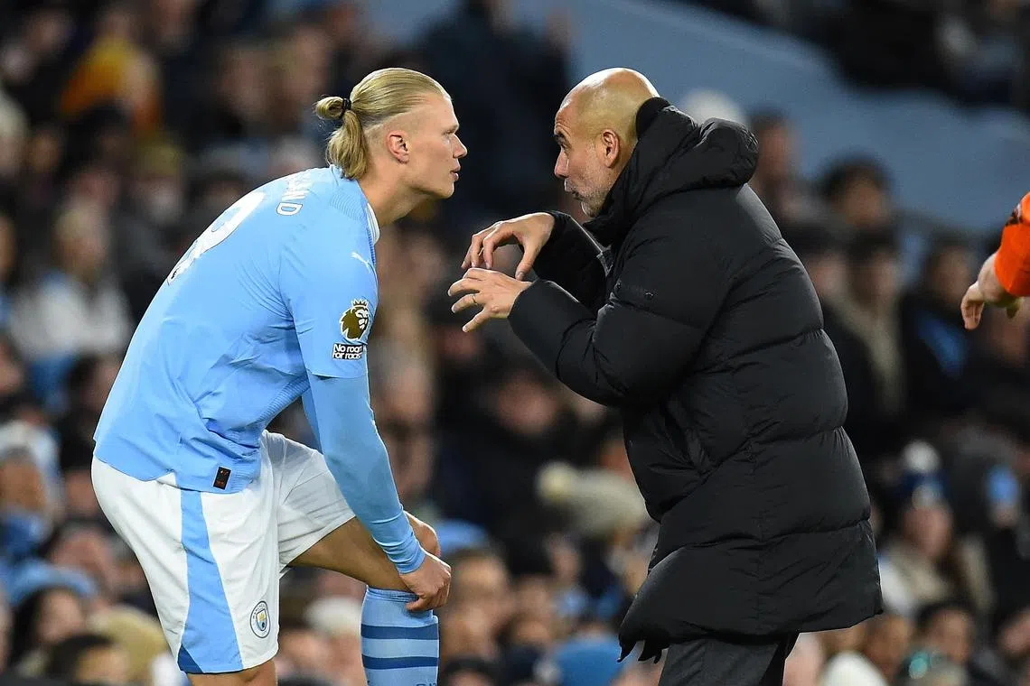 Manchester City's manager Pep Guardiola giving instructions to striker Erling Haaland before he comes on during the 3-1 win over Burnley on Jan 31.
